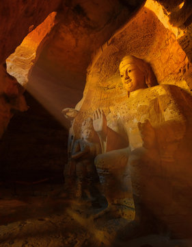 Sunlight shines on ancient Buddha statue in Yungang grottoes