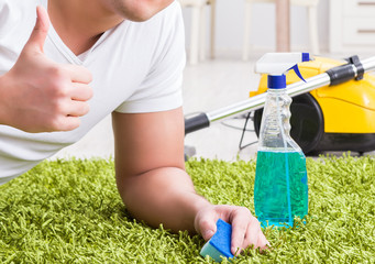 Young husband man cleaning floor at home