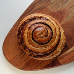 Freshly baked cinnamon buns with spices on wooden board. Top view. Sweet Homemade Pastry christmas baking. Close up. Kanelbule - swedish dessert.