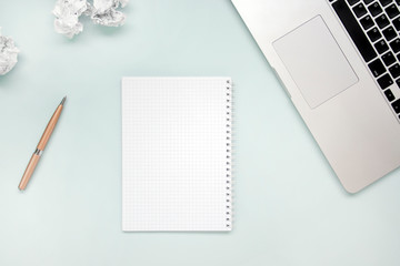 Work and creativity concept. Laptop, notepad, crumpled paper and pen top view flat lay photo with...