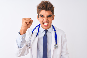 Fototapeta premium Young handsome doctor man wearing stethoscope over isolated white background angry and mad raising fist frustrated and furious while shouting with anger. Rage and aggressive concept.