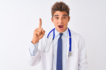 Fototapeta na wymiar Young handsome doctor man wearing stethoscope over isolated white background pointing finger up with successful idea. Exited and happy. Number one.