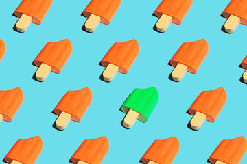 Colorful ice cream popsicle pattern on bright blue background. Pop art minimal flat lay style design, summer creative concept. Top view, flatlay. Copy space.