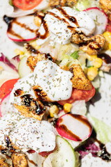 Chicken salad with tomatoes, sweet corn, cucumber, cream and lettuce. Home made food. Concept for a tasty and healthy meal. Top view.