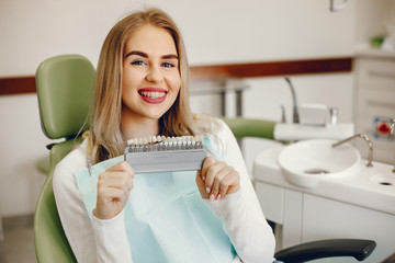 Beautiful lady in the dentist's office. Blonde sitting in a chair