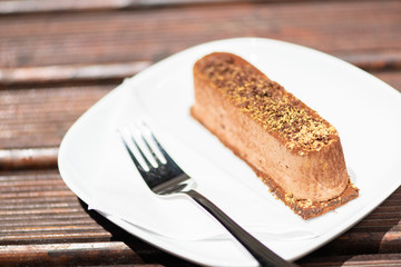 Tasty chocolate cake on the wooden table.