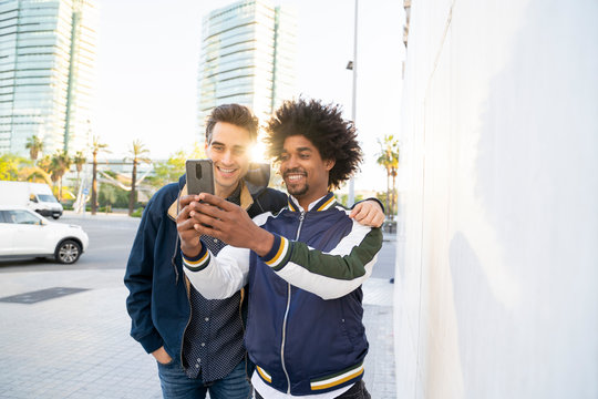 Two happy friends taking a selfie in the city, Barcelona, Spain