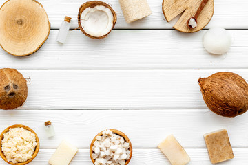 Organic cosmetics with coconut oil on white wooden background top view mockup