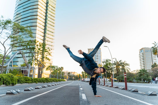 Man making a handstand on the street in the city, Barcelona, Spain