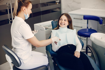 Obraz premium Beautiful lady in the dentist's office. Woman in a uniform