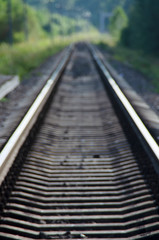 Obraz na płótnie Canvas Blurred railway tracks close-up, leading into the distance. Way to nowhere.