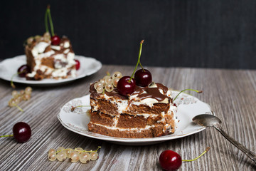 two pieces of chocolate cake with a cherry