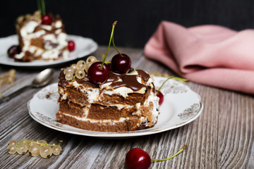 two pieces of chocolate cake with a cherry