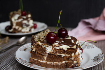 two pieces of chocolate cake with a cherry