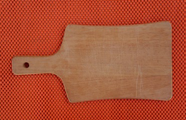 Cutting board on orange background