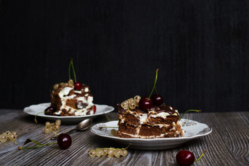 two pieces of chocolate cake with a cherry