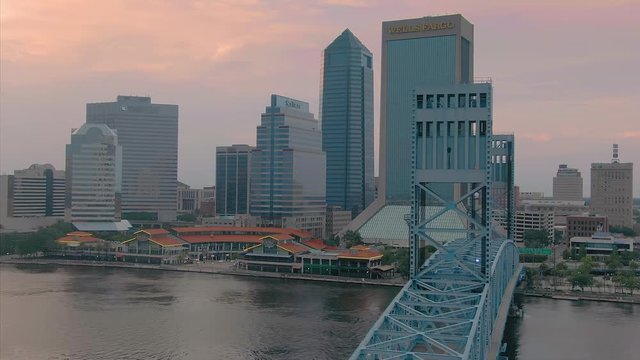 Aerial: Establishing shot of Jacksonville, st Johns river & John T Alsop Jr bridge at sunset. Florida, USA. 2 July 2019
