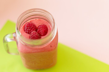 smoothies with raspberries on a colored background. selective focus. 