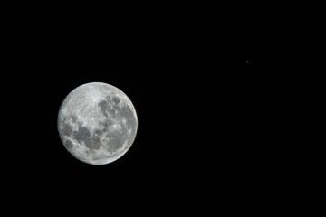 An amazing astronomy event, Saturn covered by the Moon surface awe night sky view from Santiago,...