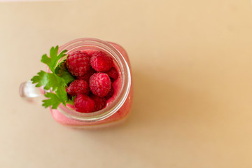 smoothies with raspberries on craft paper background