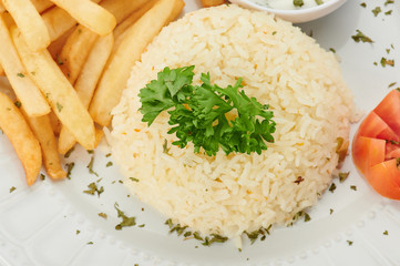 Pile of cooked rice with french fries