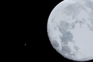 An amazing astronomy event, Saturn covered by the Moon surface awe night sky view from Santiago,...