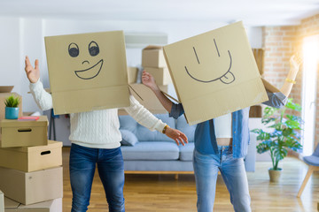 Funny couple wearing cardboard boxes with fun crazy emoji faces over head