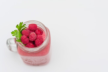 smoothies with raspberries on white background