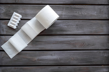 Toilet paper roll and rectal suppository for proctology diseases concept on wooden background top view mock-up