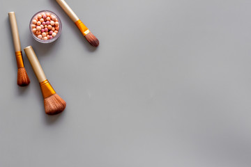 Instruments for make up with brushes, blusher on gray background top view mock up