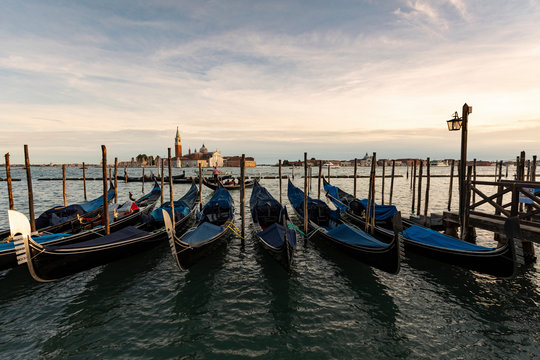 View to San Giorgio Maggiore with row of gondolas in the foreground in the evening, Venice, Italy