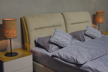 pillows on bed and luxury black lamp style on wooden table side in bedroom design, vintage process style