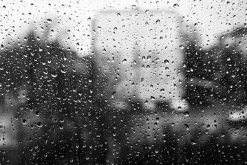 Fototapeta na wymiar Drops of water on the window glass. Black and white