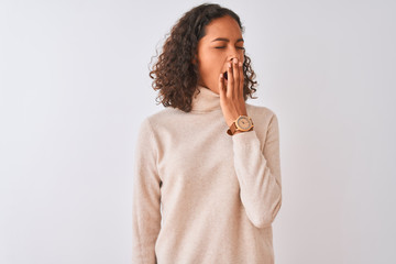 Young brazilian woman wearing turtleneck sweater standing over isolated white background bored yawning tired covering mouth with hand. Restless and sleepiness. - obrazy, fototapety, plakaty