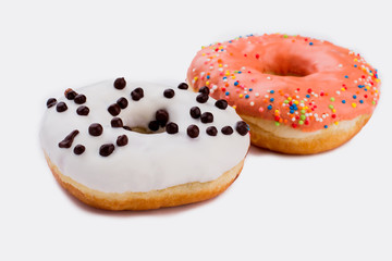 Fresh donuts with icing on white background. Pastry with colorful glaze. Concept of unhealthy food.
