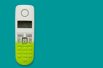 DECT phone turning into a toy phone isolated on blue background. The concept of technology...