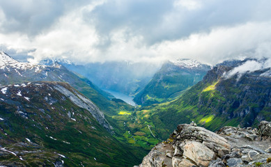 Fototapeta na wymiar View to the Geiranger fjord with green valley surrounded by mountains, Geiranger, Sunnmore region, More og Romsdal county, Norway