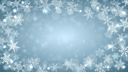 Christmas background of complex blurred and clear falling snowflakes in light blue colors with bokeh effect