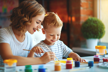 mother and child son  painting draws in creativity in kindergarten