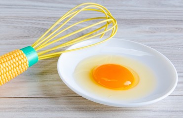 Egg in bowl and balloon whisk