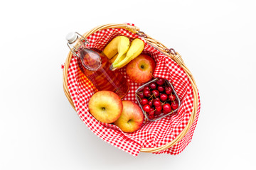 picnic in summer with products, apples, banana, cherry, drinks on white background top view