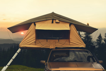 Travel to mountains on car with camping tent on roof © Oleksandr
