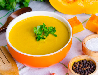 Pumpkin soup served on the table in bowl