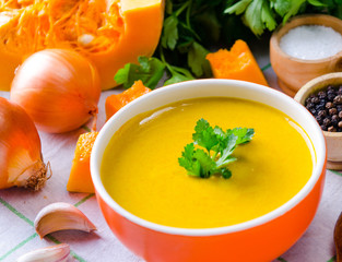 Pumpkin soup served on the table in bowl