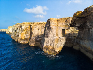 Fototapeta na wymiar Aerial view of natural arch over the sea. Wied il-Mielah canyon. Gozo island, Malta