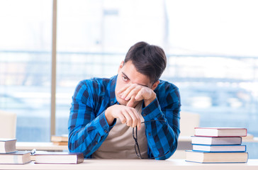 Student studying in the empty library with book preparing for ex
