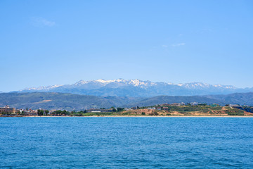 Fototapeta na wymiar Sea coast of Chania, Crete, Greece with mountains and clear blue sky on a background.