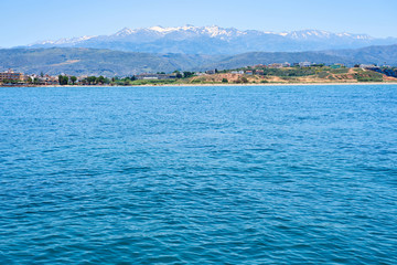 Fototapeta premium Sea coast of Chania, Crete, Greece with mountains and clear blue sky on a background.