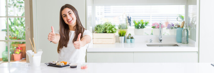Wide angle picture of beautiful young woman eating asian sushi from delivery approving doing...