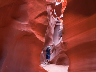 a photographer takes a shot in lower antelope canyon, az